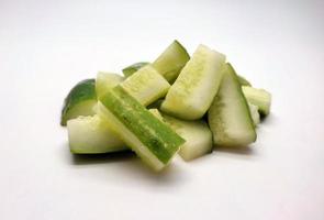 Cubed cucumber slices isolated in white background photo