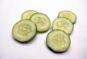 Slices of cucumbers isolated in white background photo