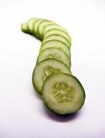 Slices of cucumbers isolated in white background photo