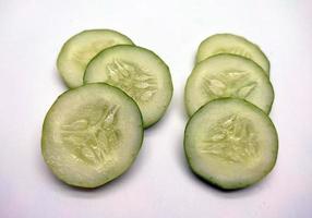 Slices of cucumbers isolated in white background photo