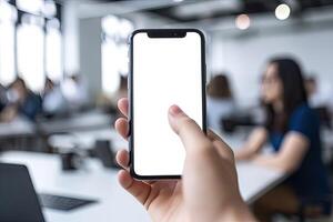 Close up view of hands holding mock up smart phone with modern office blurred background. photo