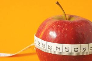 Red apple and a tape measure photo