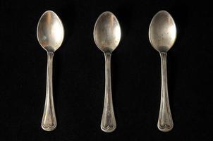 Spoons on black background photo