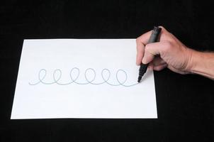 Drawing a spiral on a paper photo