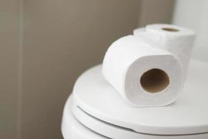 The tissue paper was placed on the toilet bowl in the bathroom. photo