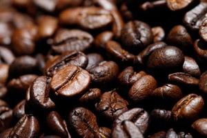photo macro close up texture of roasted coffee beans dark, can be used as a background.