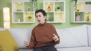 Boy thinking for a good idea. To generate ideas. The boy sitting alone at home in the living room comes to his mind with a good and good idea, he is happy and happy. video