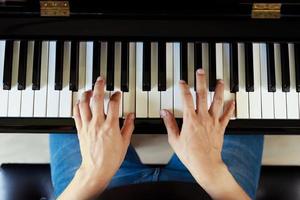 Musician playing piano performing at concert stage photo