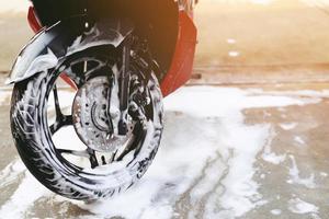 The worker is washing the motorcycle at Car Care. photo