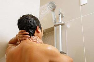 un hombre es tomando ducha en baño a hogar foto