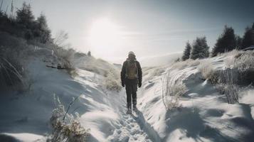 Hiker with backpack walking on snowy trail in winter mountains. Travel and adventure concept.Winter landscape photo