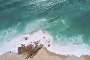 drone view of beach with waves and turquoise water photo