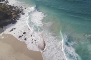 drone view of beach with waves and turquoise water photo