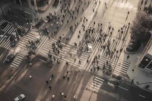 Aerial. People crowd on pedestrian crosswalk. Top view background. Toned image photo