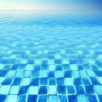 Blue clear water surface in swimming pool in a resort with sea views. Summer Vacation and rest concept. Blue tile mosaic pattern. . photo