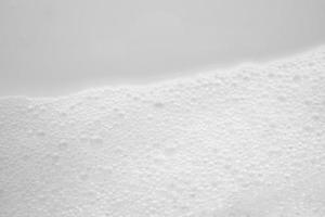 Abstract white soap foam bubbles texture on white background photo