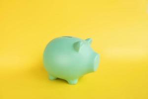Piggy bank in the form of a pig on a yellow background photo