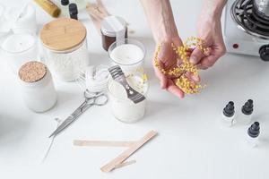 closeup of woman hands decorating handmade candle photo