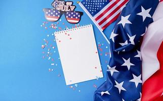 Blank white frame for mockup design on American national flag blue background with decorations photo