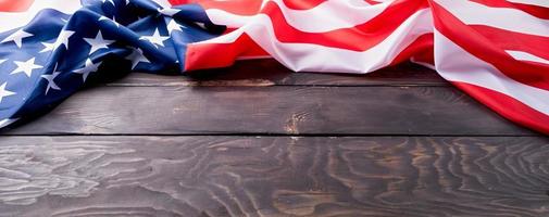 Closeup of American flag on dark wooden background photo