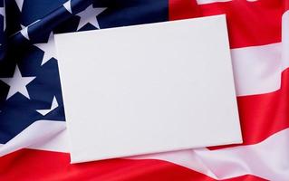 Blank white canvas frame for mockup design on American national flag background photo