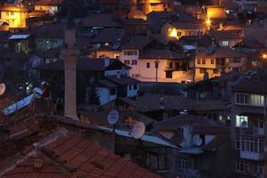 houses with a light on in the middle of the night photo