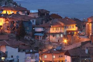 houses with a light on in the middle of the night photo