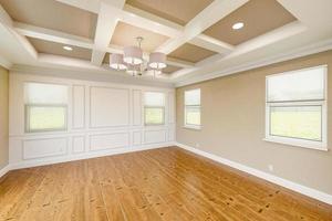 Beautiful Tan Custom Master Bedroom Complete with Entire Wainscoting Wall, Fresh Paint, Crown and Base Molding, Hard Wood Floors and Coffered Ceiling photo