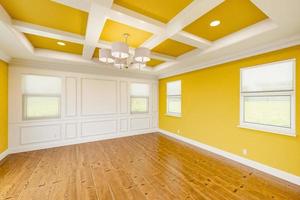 Beautiful Yellow Custom Master Bedroom Complete with Entire Wainscoting Wall, Fresh Paint, Crown and Base Molding, Hard Wood Floors and Coffered Ceiling photo