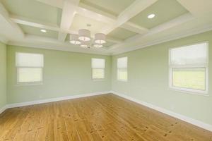 Beautiful Light Green Custom Master Bedroom Complete with Fresh Paint, Crown and Base Molding, Hard Wood Floors and Coffered Ceiling photo