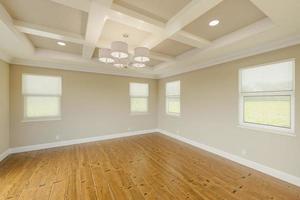 Beautiful Tan Custom Master Bedroom Complete with Fresh Paint, Crown and Base Molding, Hard Wood Floors and Coffered Ceiling photo