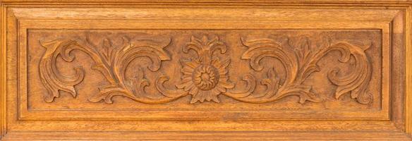 Pattern of flower carved on wood background. Traditional Thai style pattern photo