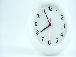 Front view of a white clock located on a table inside a house. video