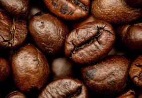 Espresso roasted coffee beans isolated in black background close up photo