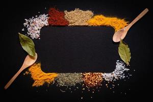 Set of Various spices on black stone table. Top view with copy space. photo