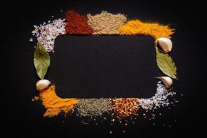 Set of Various spices on black stone table. Top view with copy space. photo