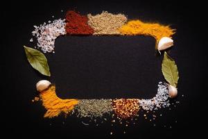 Set of Various spices on black stone table. Top view with copy space. photo