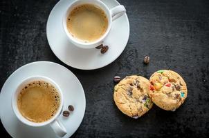 Two cups of coffee with  cookies photo