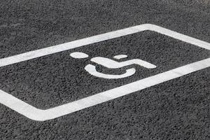 Parking spot for disabled drivers, road marking on asphalt road photo
