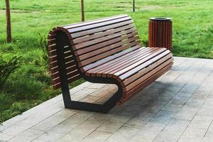 modern park bench and waste bin made of wooden planks photo