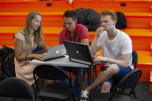 Belarus, Minsk city, August 06, 2017. Programmers Office. IT people ponder the project. A group of programmers at a table with computers. photo