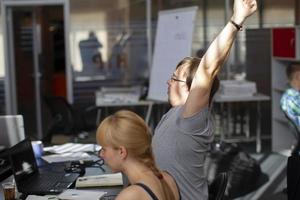 Belarus, Minsk city, August 06, 2017. Programmers Office. IT people at work. Programmers at the tables with computers. photo
