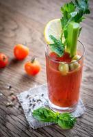 Bloody Mary cocktail on the wooden background photo