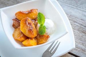 Caramelized peaches with vanilla ice cream photo