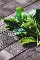 Green spinach leaves on wooden table prepared for cooking photo