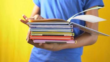 clever thoughtful guy reading a stack of books video