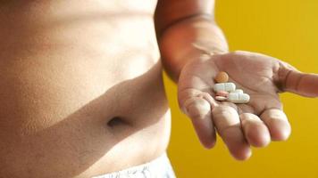 holding excessive belly fat and medical pills , video