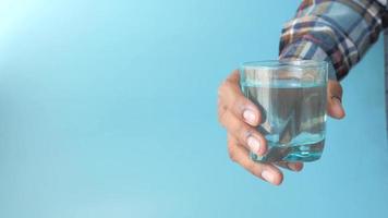 Hand pick a glass of water on table video