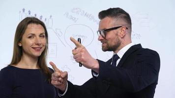 Man and woman rejoice in success and having fun in a modern glass office video