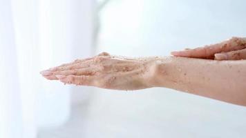 Close-up woman is hands with coffee massage scrub . Cosmetology, hand care, spa cosmetics, beauty concept. video